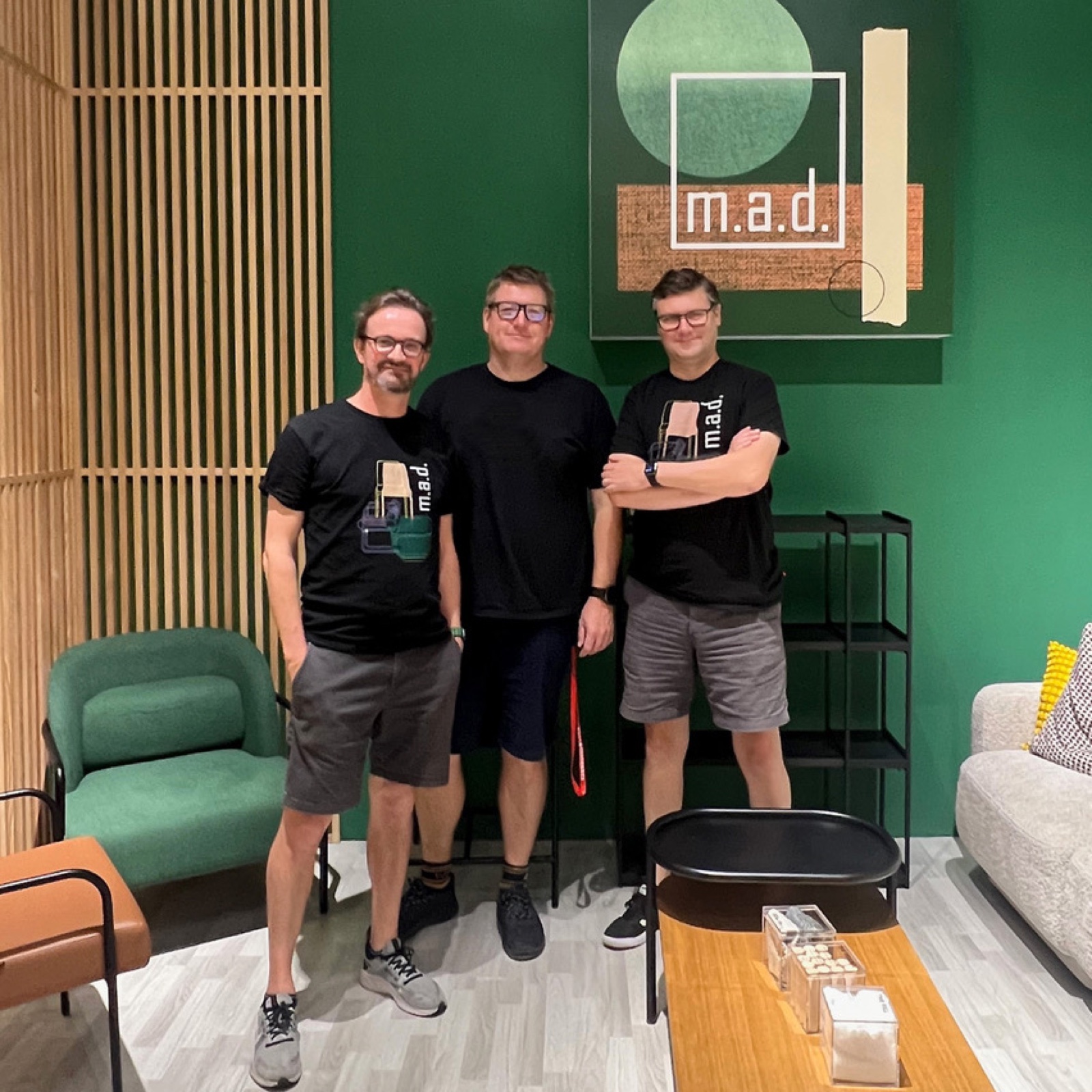 The m.a.d. furniture design team standing in their showroom, surrounded by their furniture